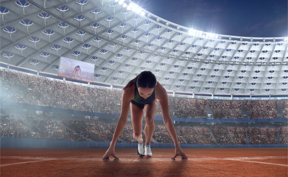 Female runner athlete in a stadium with high performance